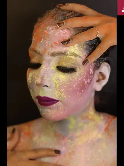 A creative makeup look for Holi, using colored powders to create a beautiful and expressive abstract design on the face.