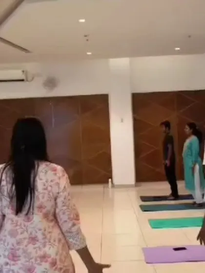 Participants beginning a session with gentle standing movements before settling into the sound bath.