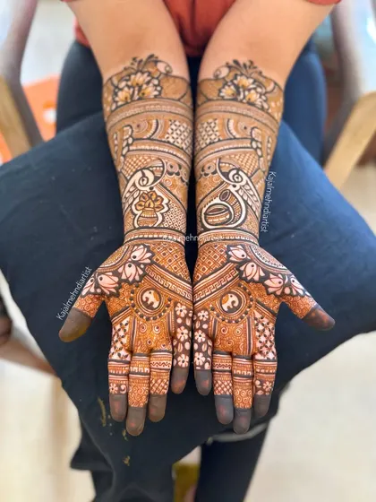 A beautiful full bridal design featuring kalash motifs, yin-yang symbols for balance, and elegant peacocks.