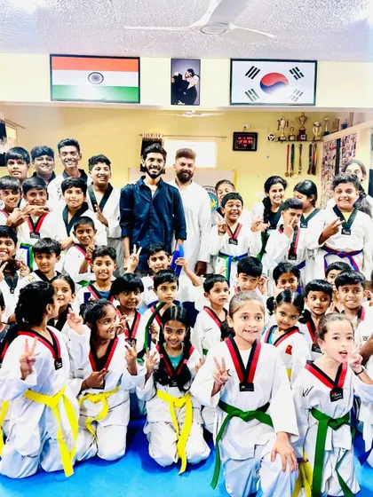 The joy and excitement are clear on everyone's faces in this group photo after the belt ceremony.