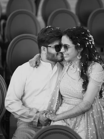 A cool and happy black and white portrait of a couple wearing sunglasses. This candid shot captures their modern style and the joyful, relaxed vibe of their engagement session.