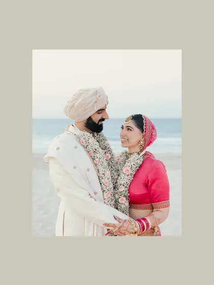 A serene beach portrait of Akanksha and Yash in Abu Dhabi. The soft, muted tones and the ocean backdrop create a calm and romantic mood.