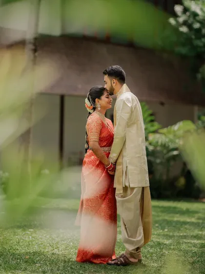 A quiet, intimate portrait framed by lush greenery. We use natural elements to create a sense of romance and tranquility in our couple's wedding photos.