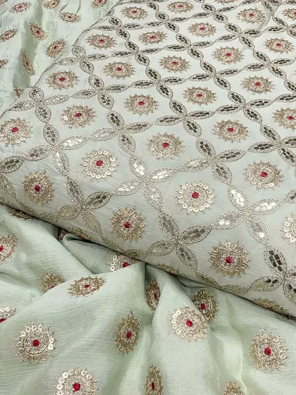 A full view of the off-white Chinon fabric, showing the consistent and detailed embroidery pattern. This textile is perfect for creating coordinated sets for special occasions.