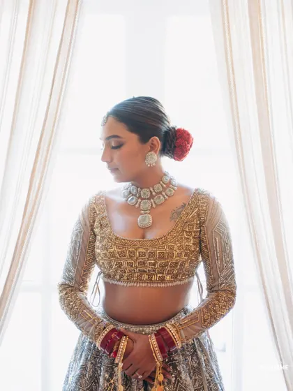 A quiet, reflective moment. This shot highlights the clean lines of her hairstyle and the beautiful shimmer of her blouse.
