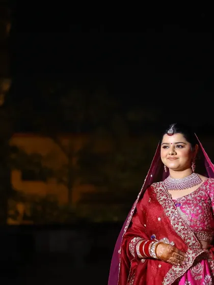 An outdoor bridal portrait taken at night, with soft lighting creating a serene and elegant mood.