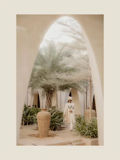 The groom making his entrance through a beautiful arched hallway. This is a powerful, cinematic shot that makes him look like a king.