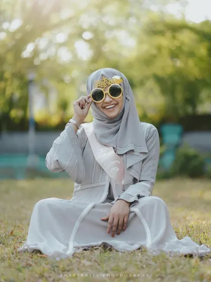 A fun and playful shot from a bridal shower, with the bride-to-be smiling brightly in her novelty glasses.