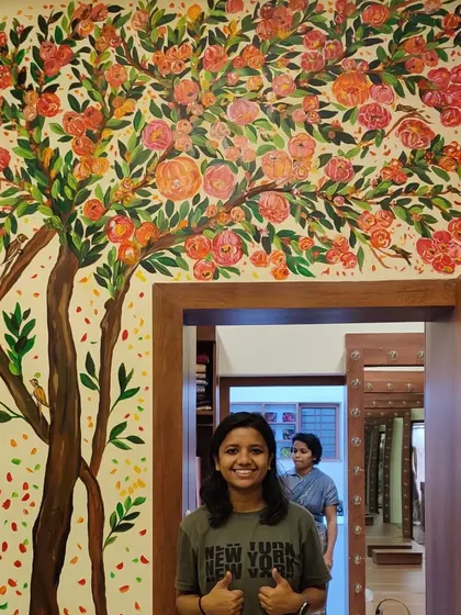 A happy photo with the completed boutique mural. It was a pleasure to create a piece that enhances the brand's luxurious aesthetic.