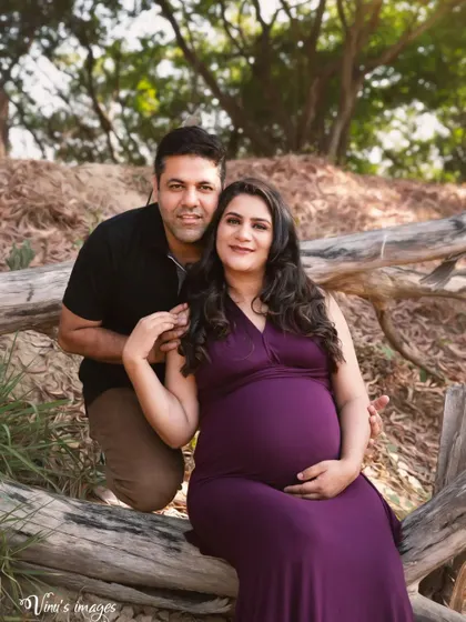 A lovely portrait of the couple seated together on a log. Their close and comfortable pose reflects their strong partnership.