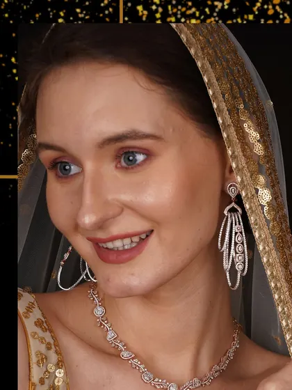 A model adorned in a beautiful diamond necklace and dramatic chandelier earrings. This look is all about glamour and making a memorable entrance.