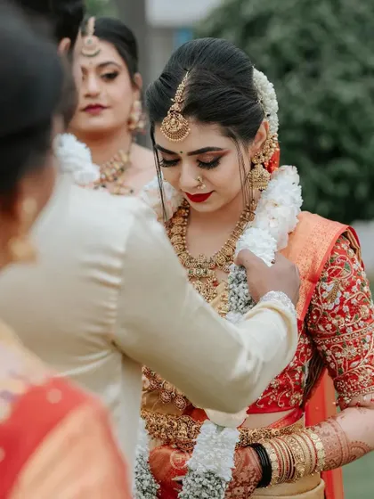 A candid moment from the wedding, with the bride looking beautiful and her henna on full display.