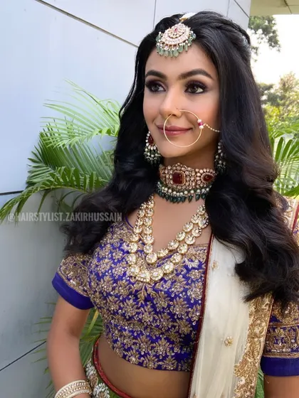 A simple and elegant half-up style with soft waves, perfect for a bride who wants a natural and understated look.