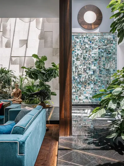 This view from the living room looks into the central courtyard, where the 30-foot-high ceramic and sandstone murals serve as a breathtaking focal point. The design ensures that art and nature are visible from every part of the home.