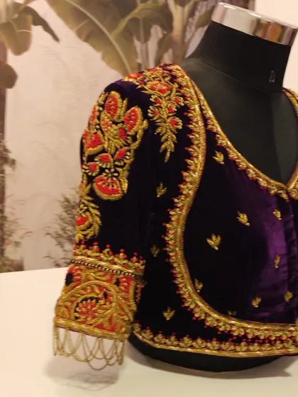Another angle of the heavily embroidered purple velvet blouse, highlighting the rich texture and craftsmanship.