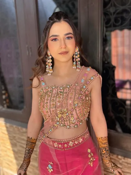 Mehndi ready! This look features soft pink eyeshadow and glowing skin, paired with a trendy half-up hairstyle.