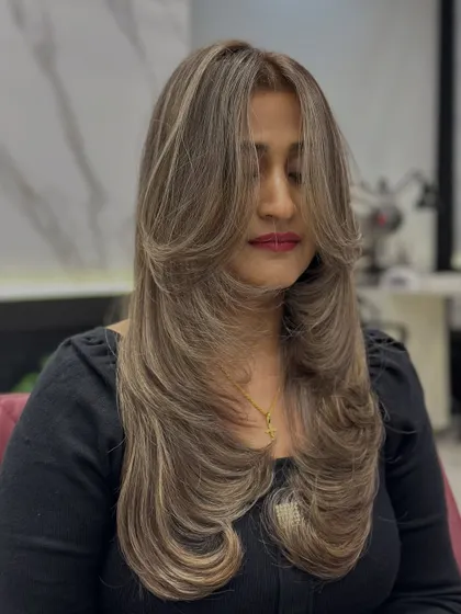 A close-up of the global ash blonde with highlights, showing the intricate layers and cool tones.