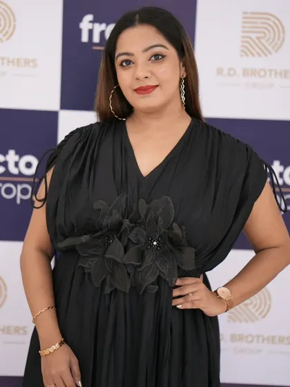 A close-up shot against the branded backdrop for Fracto Prop. This shows how I present myself professionally at corporate events, ready for photo opportunities with clients and guests.