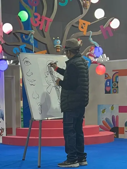 A shot of me demonstrating how to draw different facial features on the whiteboard during the workshop.