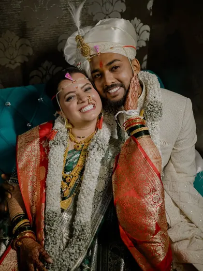 A joyful, candid photo of the couple after their wedding ceremony, capturing their bright smiles and happiness.