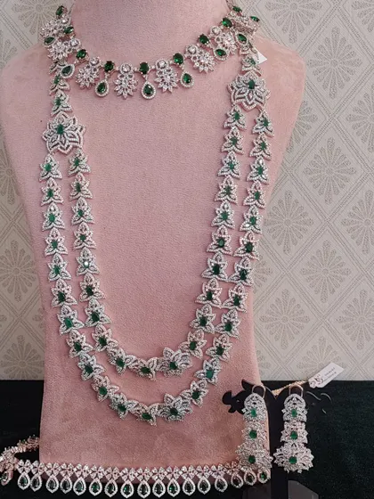 A beautiful floral-inspired AD stone set with green stones. This set includes a choker, a layered necklace, and a matching waist belt.