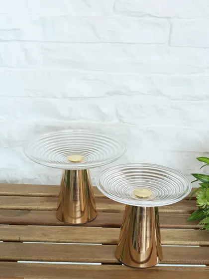 The Vesper high tea stand, featuring a rippled glass top and a polished gold base. Its modern, sculptural design is perfect for creating an indulgent and stylish tea-time experience.