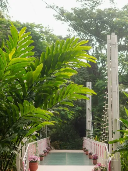 Every step leads to blissful beginnings. We believe in transforming every part of the venue, including this entrance bridge, to be part of the wedding's magical story.
