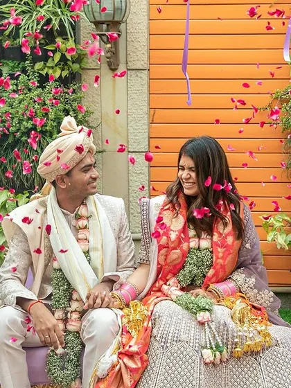 A beautiful moment between the couple amidst a shower of petals at their intimate Delhi wedding.