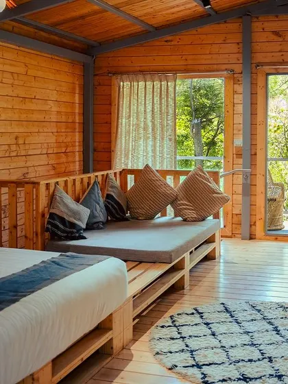 The spacious interior of our wooden cabins includes comfortable seating areas, perfect for groups to relax together.