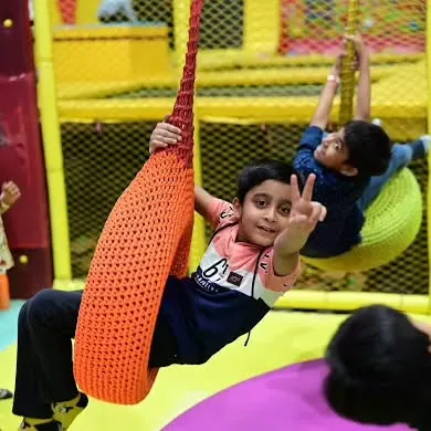 These boys are having a great time on our colorful swings. The soft play area has a variety of swings and structures to explore.