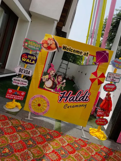A fun and quirky photo booth for a Haldi ceremony. The frame is filled with funny and relatable signs in Hinglish, making it a huge hit among guests for taking memorable pictures.