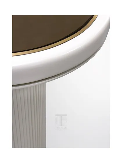 A close-up of the side table, showing the intricate detailing of the fluted base and the elegant brass trim.