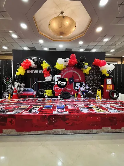 The full stage setup for the Ferrari birthday bash. The combination of the custom printed floor, large-scale props, and balloon arrangements created a truly impressive focal point.