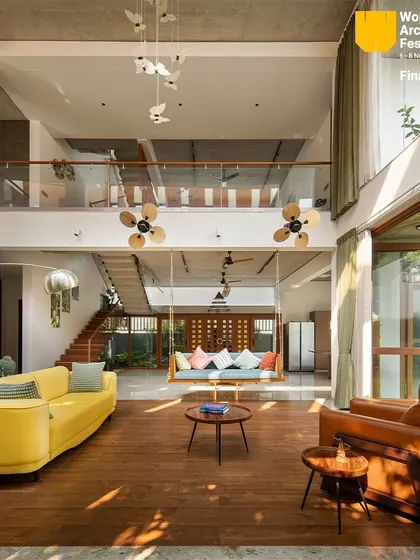 Another perspective of the open-plan living and dining area, showing how sunlight filters through the space.