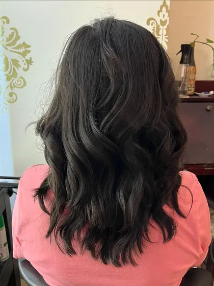 The back view of Anupama's layered cut.