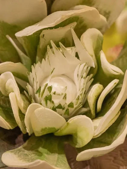 A macro shot of a beautiful green and white artificial flower, highlighting the intricate details and realistic texture that make my arrangements so special.