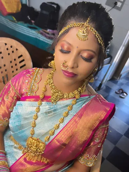 A close-up of Inchara's eye makeup, which features a blend of pink and gold tones to match her vibrant saree.