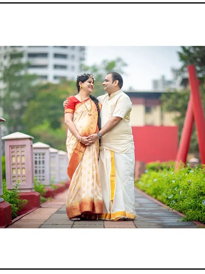 A beautiful portrait of a couple in traditional South Indian attire, walking together in a park.