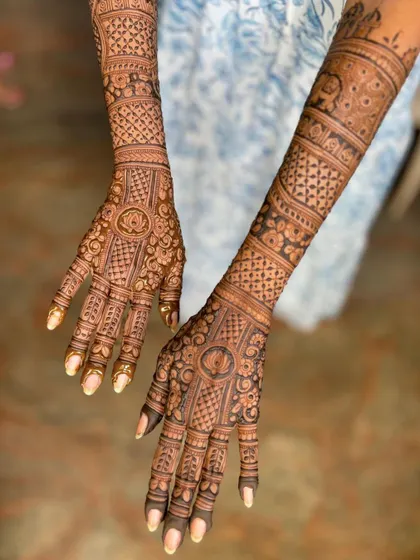 An angled view of this special request mehendi, showing the intricate work on the back of the hands.