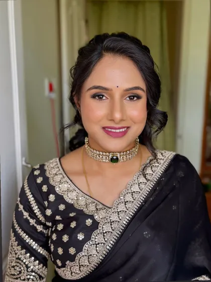 Shwetha looking lovely for a family event. This look features a defined eye and a bold magenta lip, paired with an elegant updo.