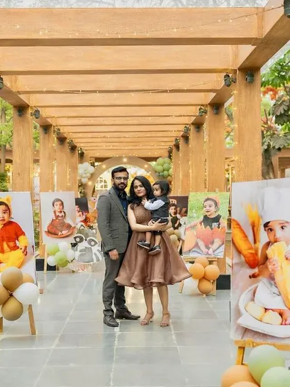 A beautiful family portrait in the woodland party's entrance walkway, which is lined with adorable photos of the birthday boy from his first year.