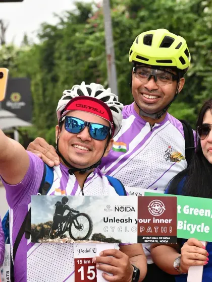 Supporting the cause at a cyclothon. A selfie of our members holding signs and smiling for the camera.