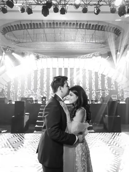 The same romantic first dance, in timeless black and white. This emphasizes the emotion and the beautiful stage lighting.