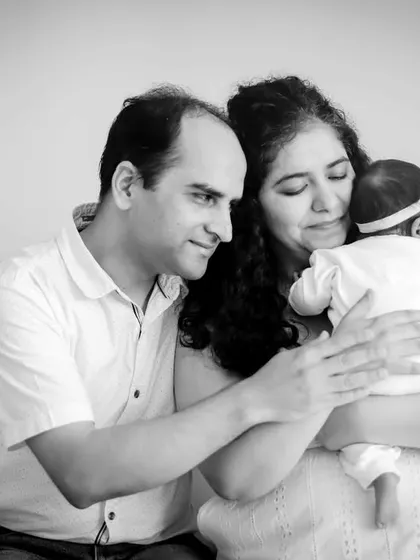 A quiet cuddle on the couch. This black and white photo captures the comfort and security of being a new family at home.