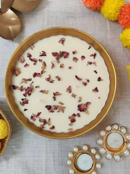 A beautiful brass bowl candle filled with soy wax and topped with dried rose petals. A perfect gift for friends and family.