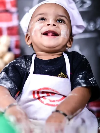 Meet the world's cutest little chef. Themed sessions like this are my specialty, and I provide all the props and costumes. We had so much fun with this messy, flour-dusted shoot, capturing this little one's pure, uninhibited joy.