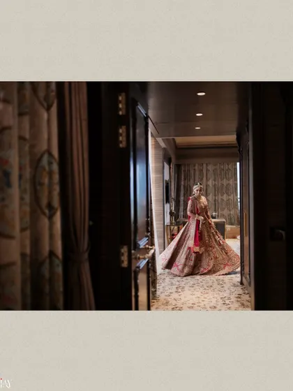 A wide shot of the bride twirling in a luxurious hotel corridor.