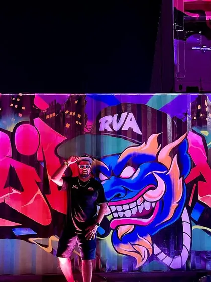 The vibrant colors of the graffiti wall under the festival lights.