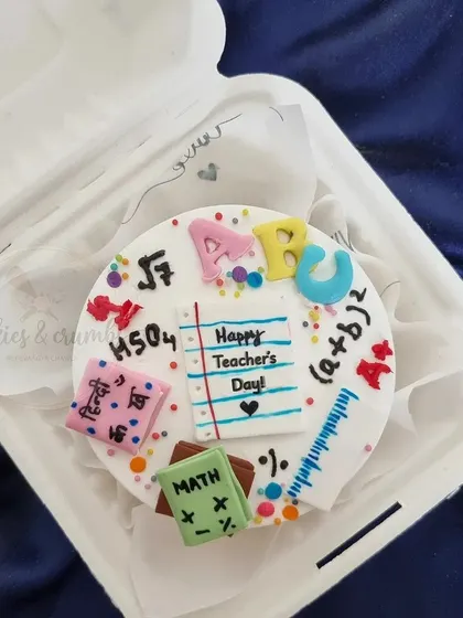 A super fun and colorful bento cake I made for a teacher. It's covered in cute, edible details like math formulas, books, and the alphabet.