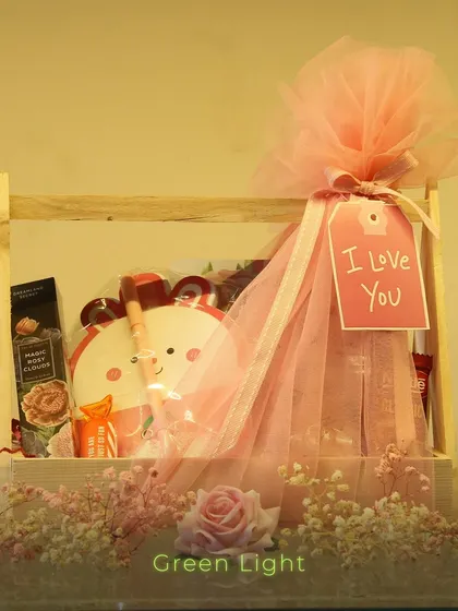 A sweet and simple gift in a wooden crate. This hamper features a cute bear-themed item and is wrapped in pink tulle with an "I Love You" tag.